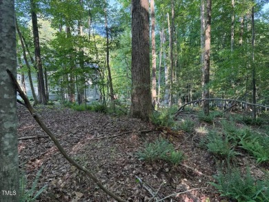 Private & wooded building lot on a quiet street of custom homes on River Golf and County Club at Lake Royale in North Carolina - for sale on GolfHomes.com, golf home, golf lot