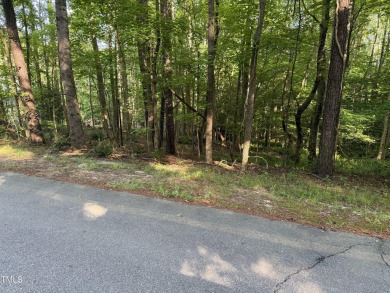 Private & wooded building lot on a quiet street of custom homes on River Golf and County Club at Lake Royale in North Carolina - for sale on GolfHomes.com, golf home, golf lot