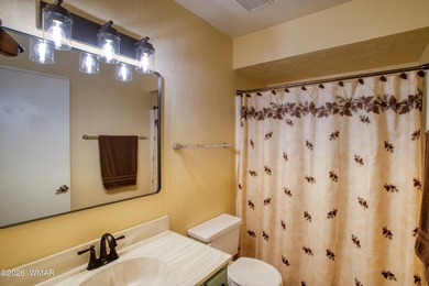 Surrounded by tall pines, this fully-furnished lower-level condo on Pinetop Lakes Golf and Country Club in Arizona - for sale on GolfHomes.com, golf home, golf lot