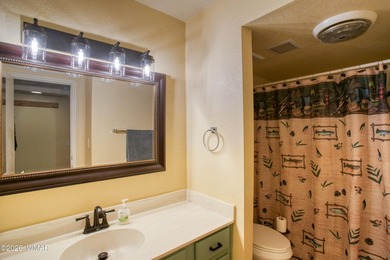 Surrounded by tall pines, this fully-furnished lower-level condo on Pinetop Lakes Golf and Country Club in Arizona - for sale on GolfHomes.com, golf home, golf lot