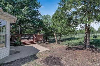 Welcome to your dream home in the exclusive, gated Raintree on Raintree Country Club in Missouri - for sale on GolfHomes.com, golf home, golf lot