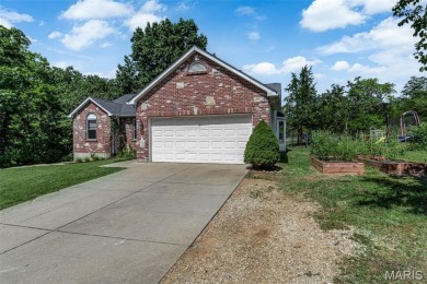 Welcome to your dream home in the exclusive, gated Raintree on Raintree Country Club in Missouri - for sale on GolfHomes.com, golf home, golf lot