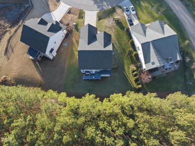 Nestled in the prestigious Hasentree Community this exceptional on Hasentree Club in North Carolina - for sale on GolfHomes.com, golf home, golf lot