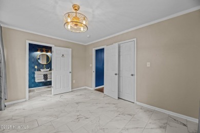 Welcome to 806 Wind Way - a hidden gem nestled in the gated on Harbour Point Golf Club in North Carolina - for sale on GolfHomes.com, golf home, golf lot