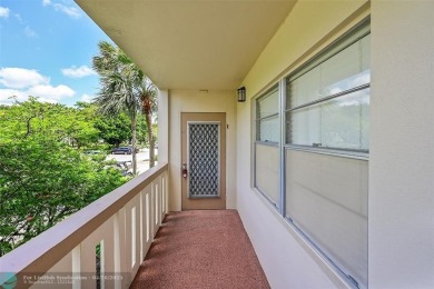 This stunning corner unit features high-quality waterproof vinyl on Wynmoor Golf Course in Florida - for sale on GolfHomes.com, golf home, golf lot