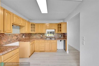 This stunning corner unit features high-quality waterproof vinyl on Wynmoor Golf Course in Florida - for sale on GolfHomes.com, golf home, golf lot