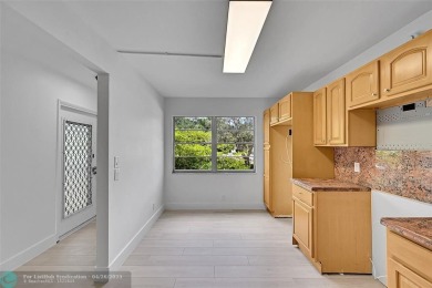 This stunning corner unit features high-quality waterproof vinyl on Wynmoor Golf Course in Florida - for sale on GolfHomes.com, golf home, golf lot