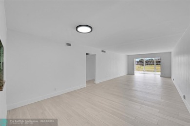 This stunning corner unit features high-quality waterproof vinyl on Wynmoor Golf Course in Florida - for sale on GolfHomes.com, golf home, golf lot