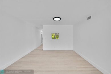 This stunning corner unit features high-quality waterproof vinyl on Wynmoor Golf Course in Florida - for sale on GolfHomes.com, golf home, golf lot