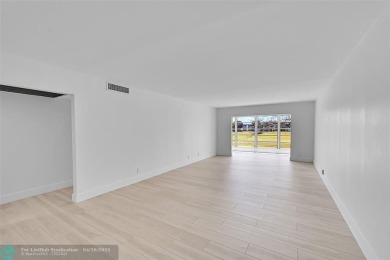 This stunning corner unit features high-quality waterproof vinyl on Wynmoor Golf Course in Florida - for sale on GolfHomes.com, golf home, golf lot