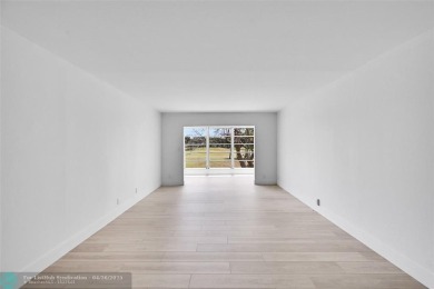 This stunning corner unit features high-quality waterproof vinyl on Wynmoor Golf Course in Florida - for sale on GolfHomes.com, golf home, golf lot