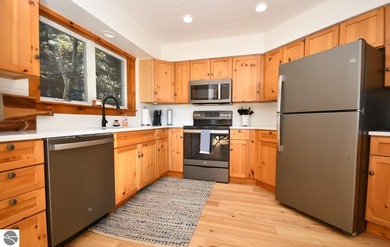 Welcome to this stunning home! Chimney Ridge 8 is situated along on Mountain Flowers Golf Course in Michigan - for sale on GolfHomes.com, golf home, golf lot