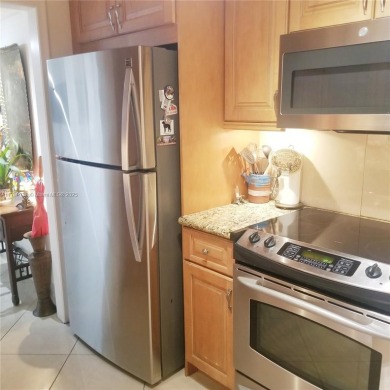 Wake up to treetop views and end your day with a stroll to on Granada Golf Club in Florida - for sale on GolfHomes.com, golf home, golf lot