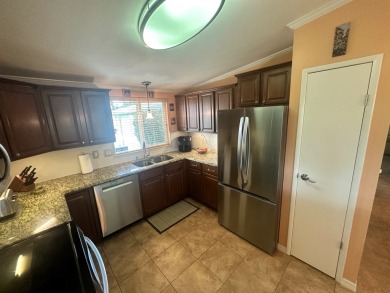 This beautiful Palm Harbour stucco home is located on the golf on Del Tura Golf and Country Club in Florida - for sale on GolfHomes.com, golf home, golf lot