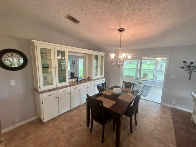 This beautiful Palm Harbour stucco home is located on the golf on Del Tura Golf and Country Club in Florida - for sale on GolfHomes.com, golf home, golf lot