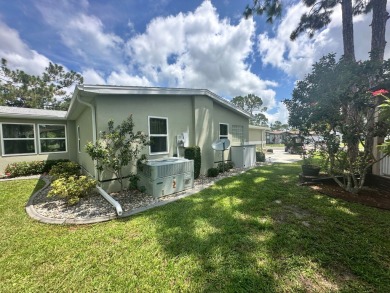 This beautiful Palm Harbour stucco home is located on the golf on Del Tura Golf and Country Club in Florida - for sale on GolfHomes.com, golf home, golf lot