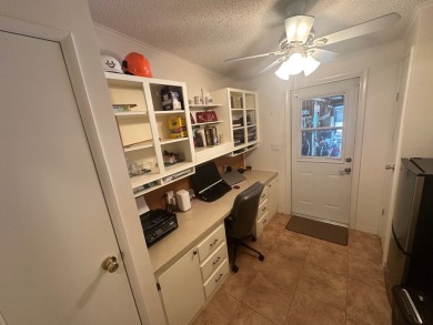This beautiful Palm Harbour stucco home is located on the golf on Del Tura Golf and Country Club in Florida - for sale on GolfHomes.com, golf home, golf lot