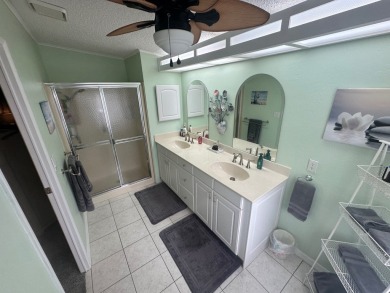 This beautiful Palm Harbour stucco home is located on the golf on Del Tura Golf and Country Club in Florida - for sale on GolfHomes.com, golf home, golf lot