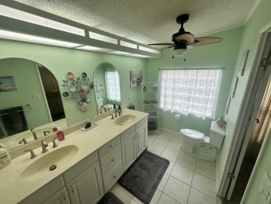 This beautiful Palm Harbour stucco home is located on the golf on Del Tura Golf and Country Club in Florida - for sale on GolfHomes.com, golf home, golf lot