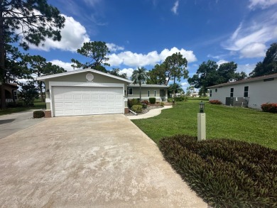 This beautiful Palm Harbour stucco home is located on the golf on Del Tura Golf and Country Club in Florida - for sale on GolfHomes.com, golf home, golf lot