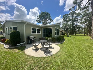 This beautiful Palm Harbour stucco home is located on the golf on Del Tura Golf and Country Club in Florida - for sale on GolfHomes.com, golf home, golf lot