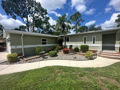 This beautiful Palm Harbour stucco home is located on the golf on Del Tura Golf and Country Club in Florida - for sale on GolfHomes.com, golf home, golf lot