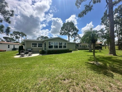 This beautiful Palm Harbour stucco home is located on the golf on Del Tura Golf and Country Club in Florida - for sale on GolfHomes.com, golf home, golf lot