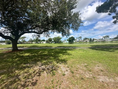 This beautiful Palm Harbour stucco home is located on the golf on Del Tura Golf and Country Club in Florida - for sale on GolfHomes.com, golf home, golf lot