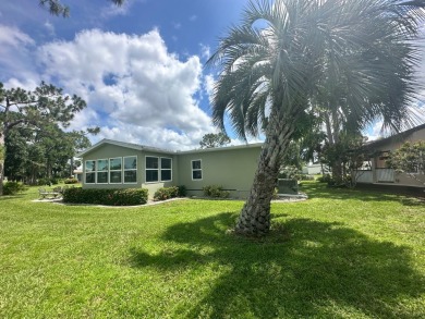 This beautiful Palm Harbour stucco home is located on the golf on Del Tura Golf and Country Club in Florida - for sale on GolfHomes.com, golf home, golf lot