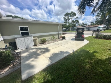 This beautiful Palm Harbour stucco home is located on the golf on Del Tura Golf and Country Club in Florida - for sale on GolfHomes.com, golf home, golf lot