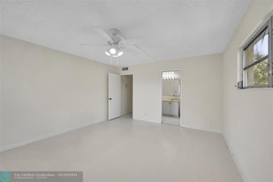 ARUBA VILLAGE IN THE HEART OF WYNMOOR WITH PANORAMIC GOLF COURSE on Wynmoor Golf Course in Florida - for sale on GolfHomes.com, golf home, golf lot