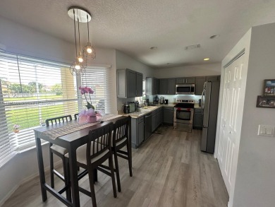 Beautiful lakefront single-family home in the sought-after Grand on Palm Beach Polo and Country Club in Florida - for sale on GolfHomes.com, golf home, golf lot