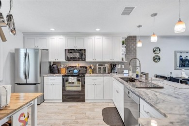 Gorgeous end-unit villa in a prime location with stunning on Highland Lakes Executive Golf Course in Florida - for sale on GolfHomes.com, golf home, golf lot