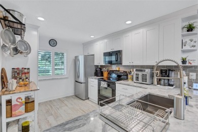 Gorgeous end-unit villa in a prime location with stunning on Highland Lakes Executive Golf Course in Florida - for sale on GolfHomes.com, golf home, golf lot