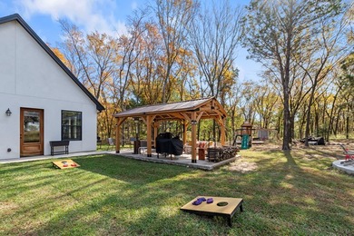 Stunning 2023 custom one-story home on a beautifully treed on Cedar Creek Country Club in Texas - for sale on GolfHomes.com, golf home, golf lot