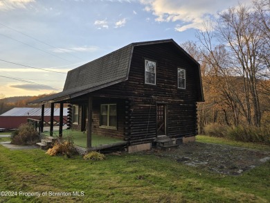 Check out this 3-bedroom, 1-bathroom log home! Featuring a cozy on Rock Creek Golf Course in Pennsylvania - for sale on GolfHomes.com, golf home, golf lot