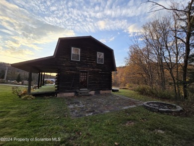 Check out this 3-bedroom, 1-bathroom log home! Featuring a cozy on Rock Creek Golf Course in Pennsylvania - for sale on GolfHomes.com, golf home, golf lot