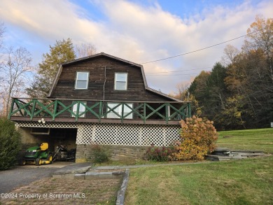 Check out this 3-bedroom, 1-bathroom log home! Featuring a cozy on Rock Creek Golf Course in Pennsylvania - for sale on GolfHomes.com, golf home, golf lot