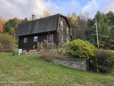 Check out this 3-bedroom, 1-bathroom log home! Featuring a cozy on Rock Creek Golf Course in Pennsylvania - for sale on GolfHomes.com, golf home, golf lot