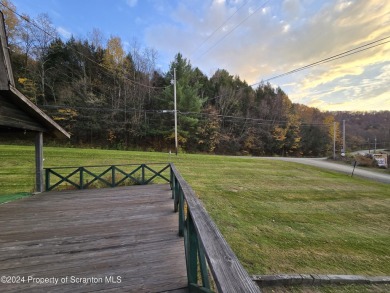 Check out this 3-bedroom, 1-bathroom log home! Featuring a cozy on Rock Creek Golf Course in Pennsylvania - for sale on GolfHomes.com, golf home, golf lot