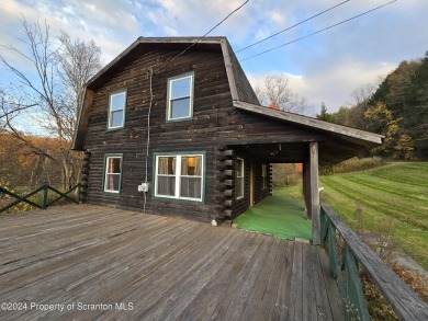 Check out this 3-bedroom, 1-bathroom log home! Featuring a cozy on Rock Creek Golf Course in Pennsylvania - for sale on GolfHomes.com, golf home, golf lot