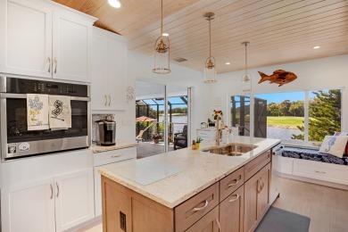 This lakefront family home is tucked away on a cul-de-sac with a on Ocean Reef Club in Florida - for sale on GolfHomes.com, golf home, golf lot