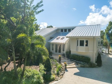 This renovated lakefront home offers comfort, style, and serene on Ocean Reef Club in Florida - for sale on GolfHomes.com, golf home, golf lot