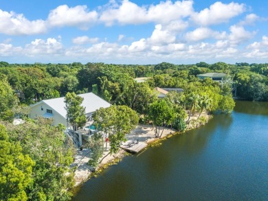 This renovated lakefront home offers comfort, style, and serene on Ocean Reef Club in Florida - for sale on GolfHomes.com, golf home, golf lot