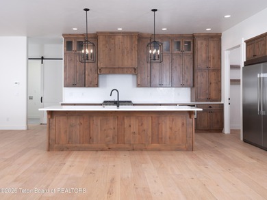 Thoughtfully oriented, this new custom home is designed around on Teton Reserve in Idaho - for sale on GolfHomes.com, golf home, golf lot