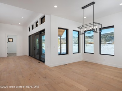 Thoughtfully oriented, this new custom home is designed around on Teton Reserve in Idaho - for sale on GolfHomes.com, golf home, golf lot