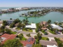 A spectacular home with 80 feet of pristine waterfront, wide for sale in Treasure Island Florida Pinellas County County on GolfHomes.com