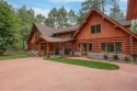 Gorgeous full log home on Big Stone Lake with Southern exposure for sale in Three Lakes Wisconsin Oneida County County on GolfHomes.com