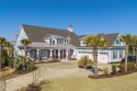 As you approach the property, you are greeted by an impressive for sale in Myrtle Beach South Carolina Horry County County on GolfHomes.com