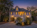 Custom designed 3 Br., 2.5 Ba. resort home is privately tucked for sale in Edisto Island South Carolina Colleton County County on GolfHomes.com